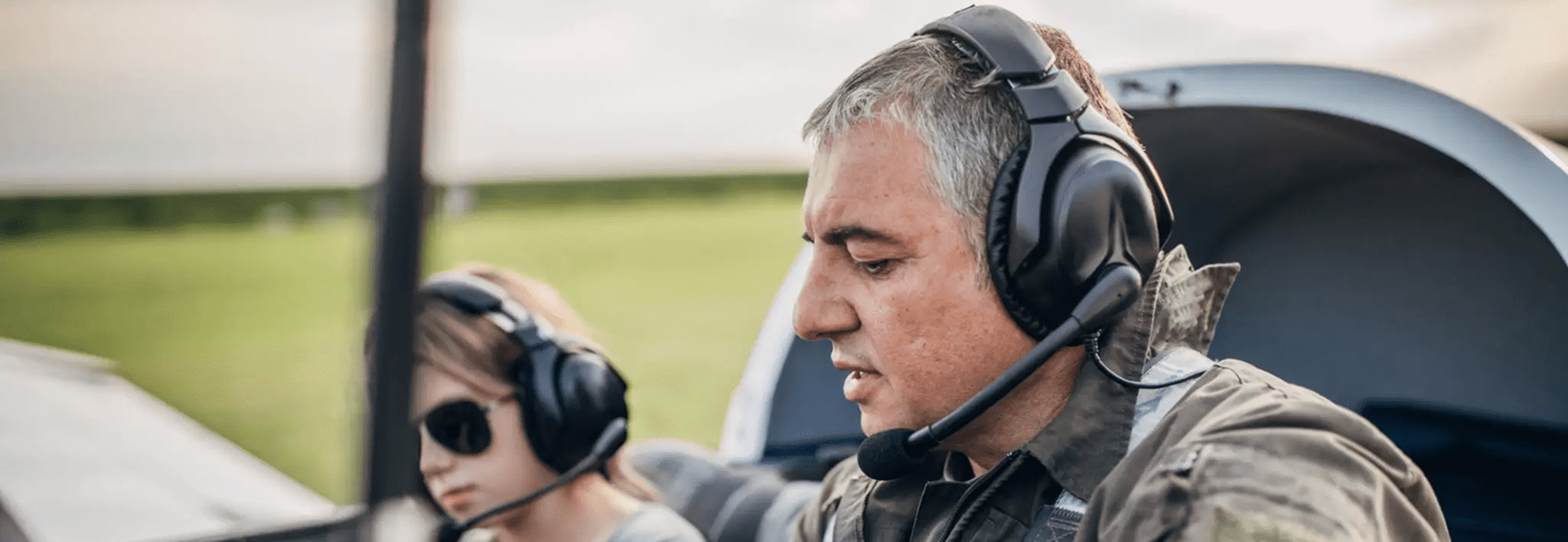 Father and child wearing headsets in plane